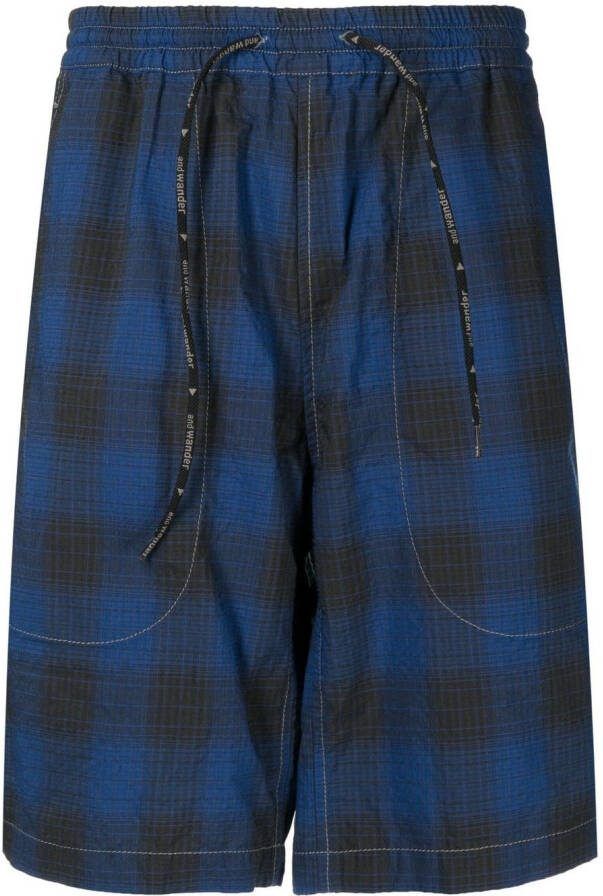And Wander Geruite trainingsshorts Blauw