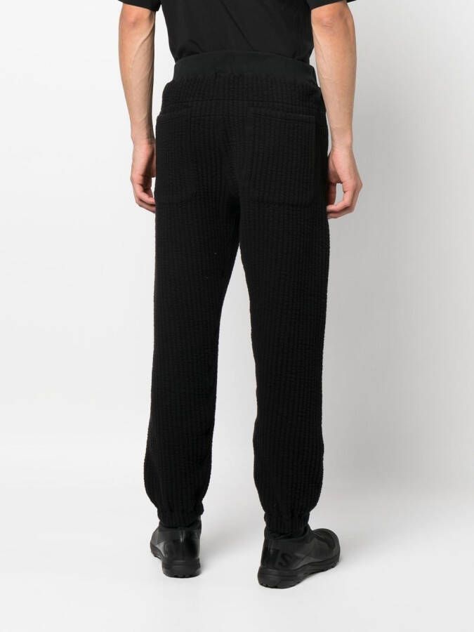 White Mountaineering Geribbelde trainingsbroek Zwart