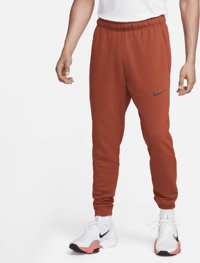 Nike Dry Dri-FIT toelopende fitnessbroek van fleece voor heren Oranje