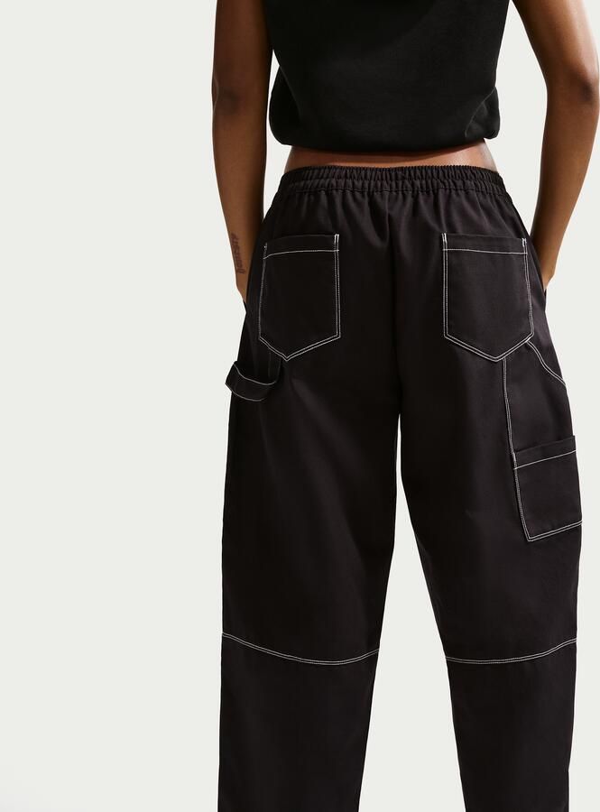 Nike ruimvallende werkbroek met lage taille voor dames Zwart