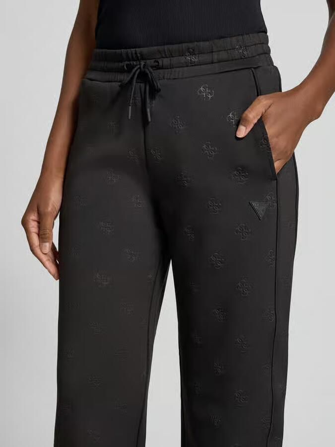 GUESS Activewear Wide fit sweatpants met all-over logoprint model 'Calista'