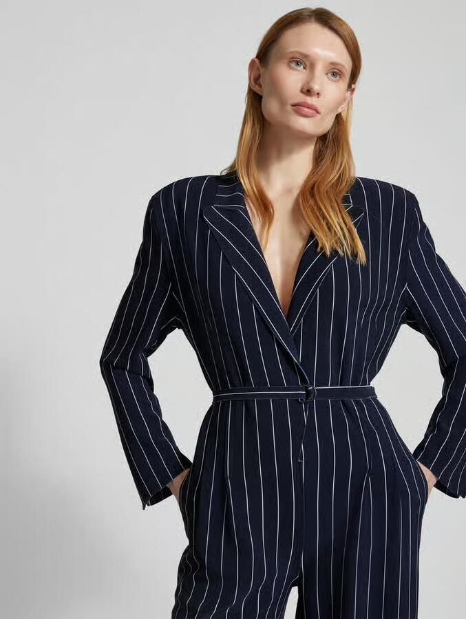 Norma Kamali jumpsuit met reverskraag