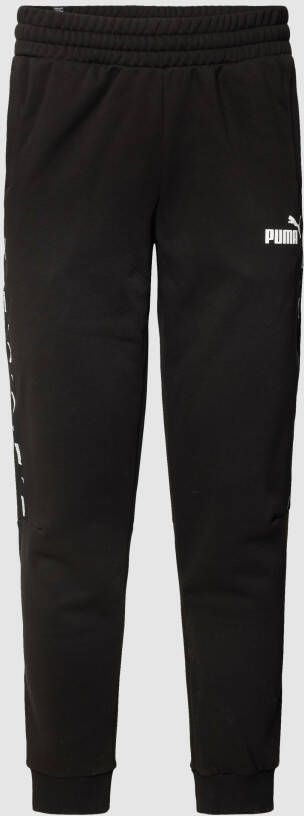 PUMA PERFORMANCE Sweatpants met labeldetail model 'ESS+ Tape Sweatpants'