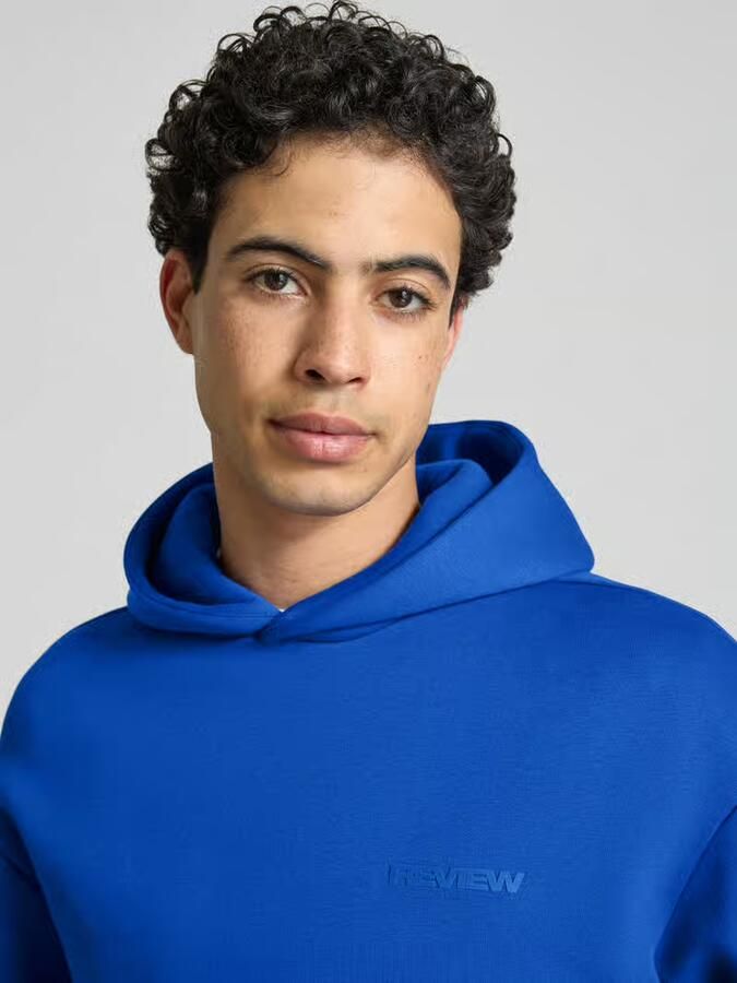 REVIEW Essentials hoodie met logo